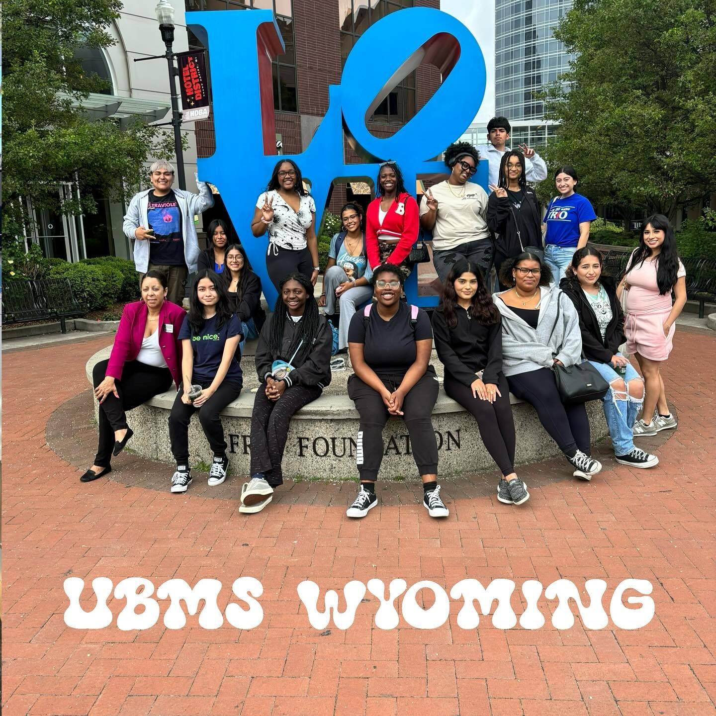 students in front of the LOVE sign